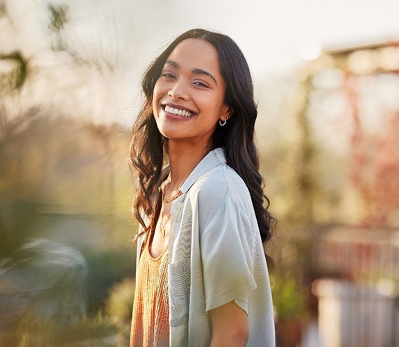 Woman smiling after learning cost of cosmetic dentistry in Channahon