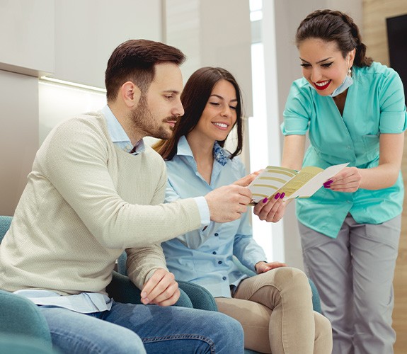 Dental team member discussing financial options with patients