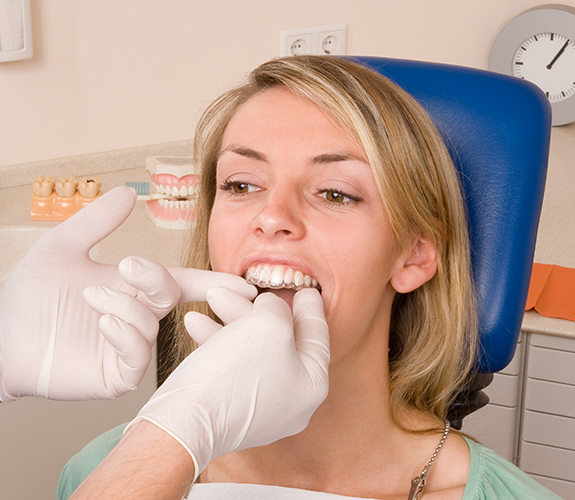 Dentist placing an Invisalign Teen tray