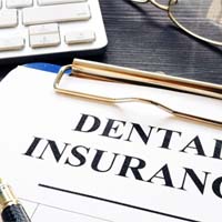 Closeup of dental insurance paperwork for the cost of Invisalign in Channahon