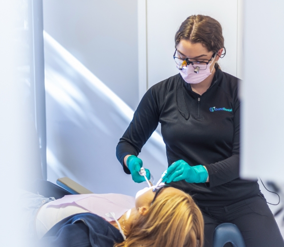 Dentist checking patient's restorative dentistry tooth colored filling treatment