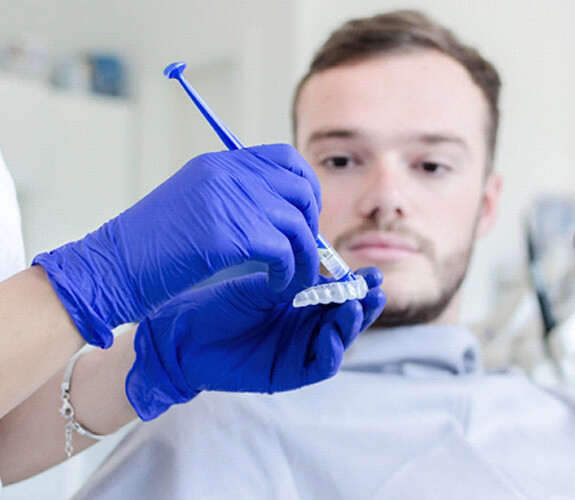 male patient learning about take-home whitening kits